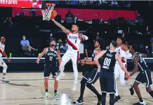Damian Lillard of the Portland Trail Blazers soars to the rim against the Brooklyn Nets on Thursday night. Portland will play ninth-seeded Memphis on Sunday for the no. 8 seed in Western Conference. GETTY IMAGES