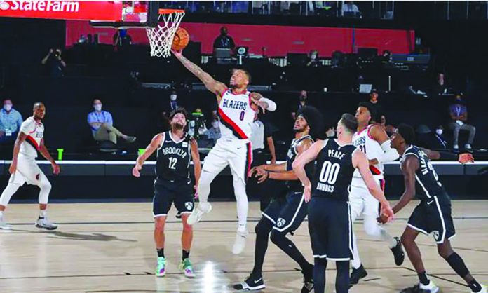PORTLAND Trail Blazers and Memphis Grizzlies will slug it out for the eighth and final playoffs seat in the Western Conference division of the 2019-2020 NBA season. Damian Lillard sizzled with 42 points to go along with 12 rebounds as the Trail Blazers lived to fight another day with a 134-133 escape over Brooklyn Nets. CJ McCollum carried the 35-39 Trail Blazers at the onset of the match to end up with 25 points, while Jusuf Nurkic had double-double 22 points and 10 rebounds. The Grizzlies, on the other hand, cruised to a 119-106 domination over Eastern Conference top-seed Milwaukee Bucks to finish with 34-39 record. Dillon Brooks drained five triples and finished with 31 points, Jonas Valanciunas had 26 points, 19 rebounds and 12 assists as Ja Morant added 12-13-10 triple-double. The Trail Blazers will have a twice-to-beat advantage over the Grizzlies for the no. 8 seed in Western Conference in the play-in series beginning Sunday. Phoenix Suns, which finished with 34-39 slate after its 8-0 record at the Orlando bubble, bowed out of contention even with its 128-102 triumph over Dallas Mavericks. San Antonio Spurs, on the other hand, also fell short from playoffs contention after a 112-118 defeat to Utah Jazz. This was the first time since 1997 that Spurs will not made it past the post-season./PN Damian Lillard of the Portland Trail Blazers soars to the rim against the Brooklyn Nets on Thursday night. Portland will play ninth-seeded Memphis on Sunday for the no. 8 seed in Western Conference. GETTY IMAGES