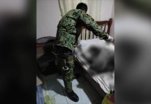 A police officer inspects the blood-soaked bed where elementary teacher Cecelia Adorador was killed. She was alone in her house in Purok 10, Barangay Aguisan, Himamaylan City, Negros Occidental, according to police investigators. HIMAMAYLAN CITY POLICE STATION