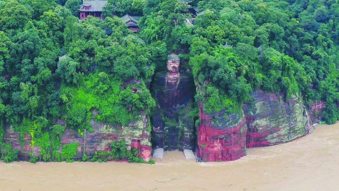This giant statue of Buddha normally sits high above the waterline but recently waters reached its base and kept rising. The last time the toes of the statue got wet was in 1949. REUTERS
