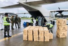 AMID COVID-19 PANDEMIC: ‘HELP WON’T CEASE’; AC Energy to expand aid to oil spill victims Uniformed officers help move boxes of food packs and relief goods from a private aircraft of AC Energy Philippines at the Iloilo Airport in Cabatuan, Iloilo. After this, the boxes are carefully disinfected to make sure they are free from the coronavirus. These goods are for families affected by the recent oil spill. RELIEF GOODS
