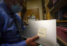 Americans face back-to-school laptop shortage A school superintendent looks at a laptop with a cracked screen at Twentynine Palms Junior High School, Tuesday, Aug. 18, 2020, in California, United States. AP