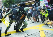 Two HK opposition lawmakers arrested Riot police (left) deploy pepper spray toward journalists (right) as protesters gathered for a rally against a new national security law in Hong Kong on July 1, 2020. AFP