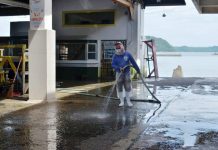 A personnel clean the Iloilo Fish Port Complex in Barangay Tanza, Iloilo City. For three days the complex would be disinfected (Aug. 2-4, 2020). Bagnetters and other fishing bancas must divert their fish haul to other ports. IAN PAUL CORDERO/PN