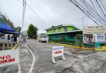 The entrance to Barangay Cuartero in Iloilo City’s Jaro district is barricaded with “lockdown” signs. A specimen extraction point has also been set up in the village after four residents there tested positive for coronavirus disease 2019. IAN PAUL CORDERO/PN