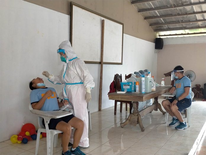 Personnel of the Iloilo City Health Office collect mouth swab samples from a police officer Personnel of the Iloilo City Health Office collect mouth swab samples from a police officer inside Multipurpose Hall of Camp Delgado. More than 250 personnel of the Police Regional Office 6 and Iloilo Police Provincial Office had their specimens collected for coronavirus disease 2019 testing. IAN PAUL CORDERO/PN