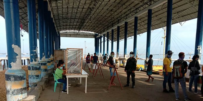 police_guimaras A police officer guards the wharf in Buenavista, Guimaras on Aug. 11. Protocols at the wharves in Guimaras have been tightened to avoid the spread of COVID-19 in the island province. BUENAVISTA MPS GUIMARAS PROVINCE