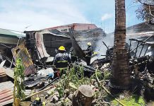 Firefighters conduct mop-up operation at a fire-hit house in Inzo Arnaldo Village, Roxas City, Capiz on Sept. 9. CAPIZ KABALAKA INFORMATION CENTER