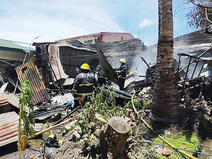 Roxas Fire_Mop up operation Firefighters conduct mop-up operation at a fire-hit house in Inzo Arnaldo Village, Roxas City, Capiz on Sept. 9. CAPIZ KABALAKA INFORMATION CENTER
