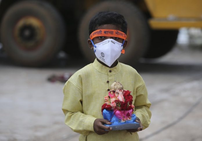 An Indian child wearing a mask as a precaution against the coronavirus carries an idol of elephant-headed Hindu god Ganesha An Indian child wearing a mask as a precaution against the coronavirus carries an idol of elephant-headed Hindu god Ganesha to immerse in Saroornagar Lake on the final day of Ganesh Chaturthi festival in Hyderabad, India, Tuesday, Sept. 1, 2020. AP