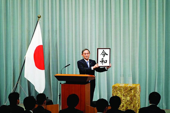 Chief Cabinet Secretary Yoshihide Suga of Japan reveals the new imperial era’s name, Reiwa, in Tokyo on April 1, 2019. THE NEW YORK TIMES