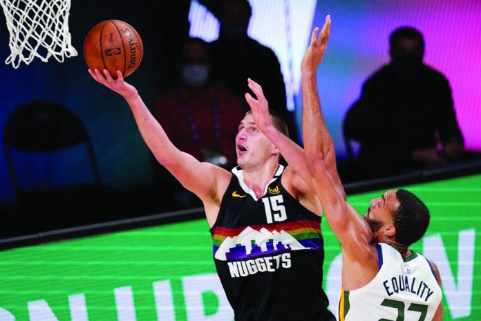 Denver Nuggets’ Nikola Jokić scores for a layup against the defense of Utah Jazz’s Rudy Gobert. Denver Nuggets’ Nikola Jokić scores for a layup against the defense of Utah Jazz’s Rudy Gobert. AP