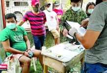 ‘Pusher’ falls in La Paz buy-bust Alleged drug pusher Joehbert Feril sits handcuffed while antidrug operatives conduct inventory of the seized item in an entrapment operation in in Barangay Caingin, La Paz, Iloilo City on Sept. 22. IAN PAUL CORDERO/PN
