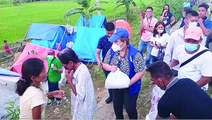 PCSO 1 Philippine Charity Sweepstakes Office (PCSO) Board Director Sandra M. Cam is assisted by PCSO Masbate personnel and some local government units personnel in the distribution of relief packs to Masbate earthquake victims from the municipalities of Palanas, Cataingan, Esperanza, and Pio V. Corpuz. PCSO MASBATE