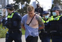Melbourne lockdown to stay; 8 charged for rally Police arrest a man as people gather at so-called “Freedom Day” protest in Melbourne on Sept. 5, 2020. JAMES ROSS