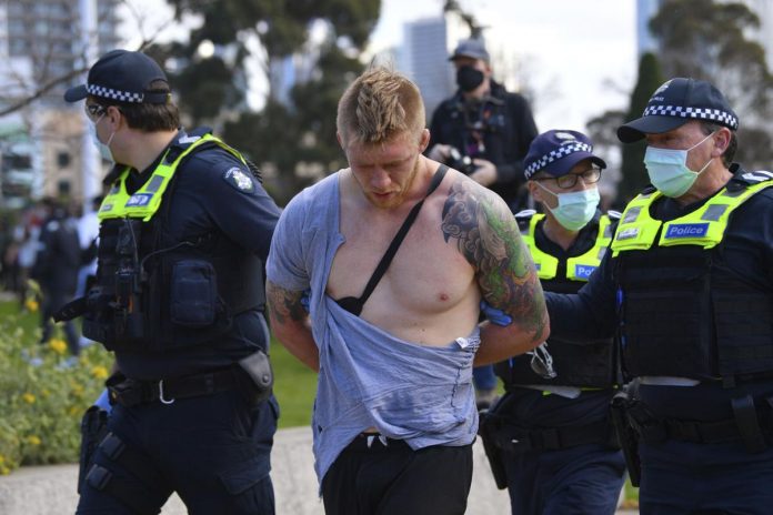 World 3 Police arrest a man as people gather at so-called “Freedom Day” protest in Melbourne on Sept. 5, 2020. JAMES ROSS