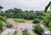 Floodwaters triggered by Tuesday’s continuous rains submerge some houses in a low-lying area of Barangay Alijis in Bacolod City. At least three villages were inundated but there were no evacuations, according to the City Disaster Risk Reduction Management Office. CONTRIBUTED PHOTO