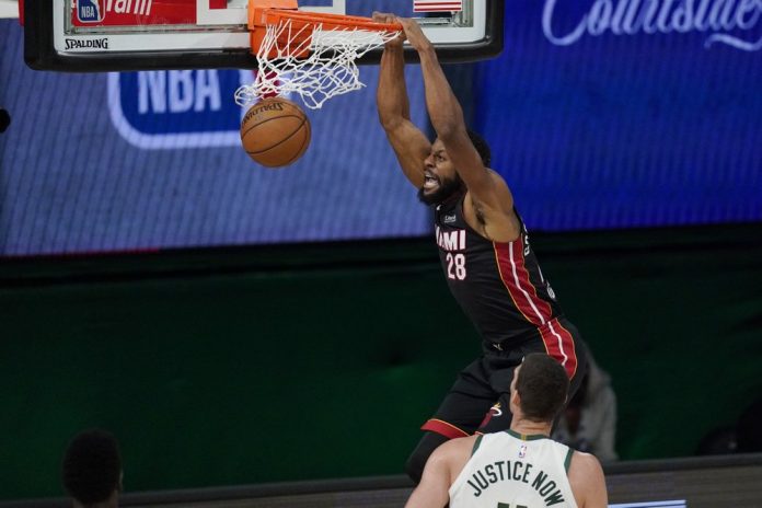 Miami Heat’s Andre Iguodala dunks in front of Milwaukee Bucks’ Brook Lopez in Game 5 of their Eastern Conference semifinals match. MARK J. TERRILL/AP PHOTO Miami Heat’s Andre Iguodala dunks in front of Milwaukee Bucks’ Brook Lopez in Game 5 of their Eastern Conference semifinals match. MARK J. TERRILL/AP PHOTO