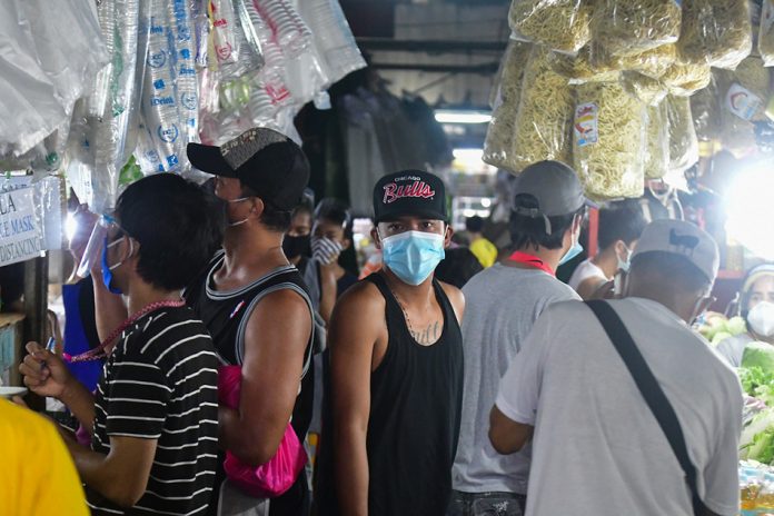 Market-goers shop inside a market in Quezon City on Aug. 26, 2020, amid the general community quarantine. ABS-CBN Market-goers shop inside a market in Quezon City on Aug. 26, 2020, amid the general community quarantine. ABS-CBN