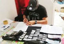 An antidrug officer inspects items seized from a man in an entrapment operation in Barangay Bata, Bacolod City Wednesday afternoon. RDEU-6