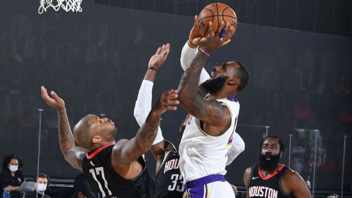 Los Angeles Lakers’ LeBron James scores against the defense of Houston Rockets’ PJ Tucker. ESPN PHOTO