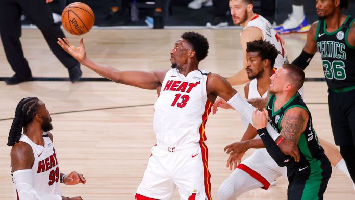 Miami Heat’s Bam Adebayo tries to get the ball while being held by the defense of Boston Celtics’ Daniel Theis in Game 2 of their Eastern Conference Finals. ESPN PHOTO