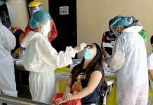 Iloilo City gov’t starts mass coronavirus test Health workers wearing protective gear extract nasal swab samples from a city government employee during the first day of mass testing at the Iloilo City Freedom Grandstand on Wednesday, Sept. 23. Panay News
