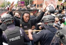 A protester clashes with police after a grand jury considering the March killing of Breonna Taylor, a Black medical worker, in her home in Louisville, Kentucky. BRYAN WOOLSTON/REUTERS