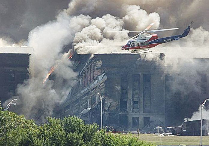 A rescue helicopter surveys damage to the Pentagon as firefighters battle flames after a hijacked airplane crashed into the U.S. military headquarters outside of Washington, Sept. 11, 2001. LARRY DOWNING/REUTERS A rescue helicopter surveys damage to the Pentagon as firefighters battle flames after a hijacked airplane crashed into the U.S. military headquarters outside of Washington, Sept. 11, 2001. LARRY DOWNING/REUTERS