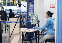 An employee waits to check passengers at Beijing Capital International Airport on Feb. 9, 2020. GIULIA MARCHI, THE NEW YORK TIMES/FILE