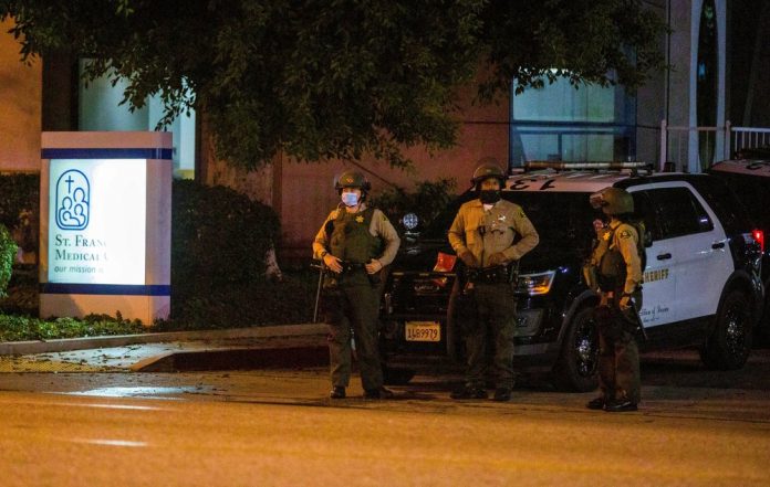 Los Angeles County Sheriff’s deputies guard the entrance to St. Francis Medical Center early Monday, Sept. 13, 2020, after two deputies were shot late Saturday, Sept. 12 while sitting inside their patrol vehicle guarding a Metro station in Compton, California. JINTAK HAN/AP PHOTO Los Angeles County Sheriff’s deputies guard the entrance to St. Francis Medical Center early Monday, Sept. 13, 2020, after two deputies were shot late Saturday, Sept. 12 while sitting inside their patrol vehicle guarding a Metro station in Compton, California. JINTAK HAN/AP PHOTO