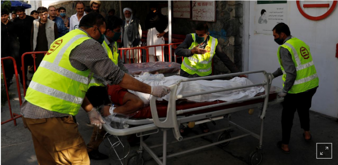 world 2 Afghan men carry an injured to a hospital after a blast in Kabul, Afghanistan on Wednesday, Sept. 9, 2020. MOHAMMAD ISMAIL/REUTERS