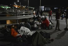 Fire sweeps through Greece’s largest refugee camp Refugees and migrants gather on a bridge as fire burns at the Moria refugee camp on the northeastern Aegean island of Lesbos, Greece, on Wednesday, Sept. 9, 2020. PANAGIOTIS BALASKAS/AP PHOTO