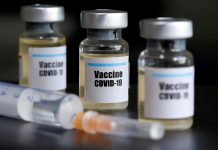 Trump contradicts CDC director on vaccine, masks Small bottles labeled with a “Vaccine COVID-19” sticker and a medical syringe are seen in this illustration taken taken April 10, 2020. REUTERS