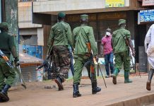 Prisoners in a Ugandan jail overpowered their guards and 219 of them escaped with at least 15 guns. RONALD KABUUBI/AP