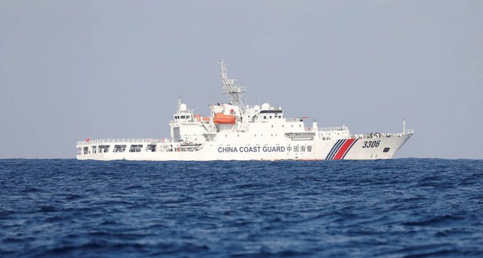FILE PHOTO: FILE PHOTO: China Coast Guard vessel patrols at the disputed Scarborough Shoal A China Coast Guard vessel patrols at the disputed Scarborough Shoal April 5, 2017. Picture taken April 5, 2017. REUTERS/Erik De Castro/File Photo