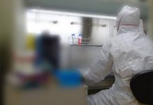 Jiro Yasuda, a professor at Nagasaki University, conducts an experiment to examine the effectiveness of Sharp's Plasmacluster air purifying technology against novel coronavirus particles in the air. | COURTESY OF SHARP