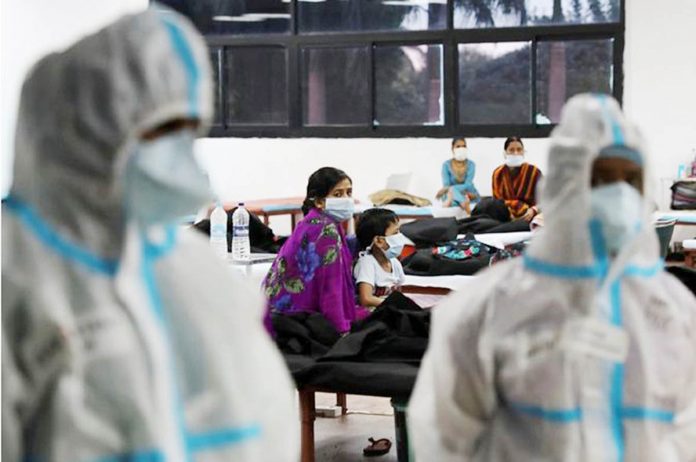 World - India 2 A woman sits with her child inside a quarantine center for COVID-19 patients amidst the spread of the disease at an indoor sports complex in New Delhi, India, September 22, 2020. REUTERS