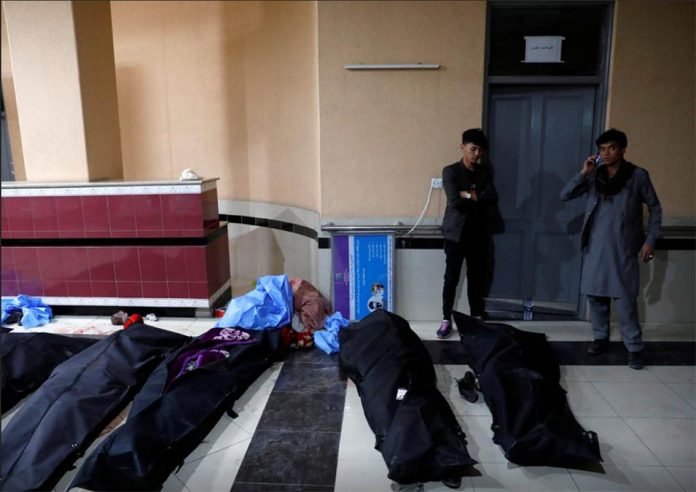 Afghan men look for their relatives at a hospital after a suicide bombing in Kabul, Afghanistan on Oct. 24, 2020. REUTERS