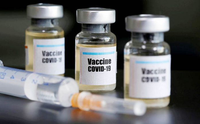FILE PHOTO: Small bottles labeled with a "Vaccine COVID-19" sticker and a medical syringe are seen in this illustration The European Union seals a deal with Johnson & Johnson to supply up to 400 million doses of its potential COVID-19 vaccine. YAHOO! NEWS/ FILE PHOTO