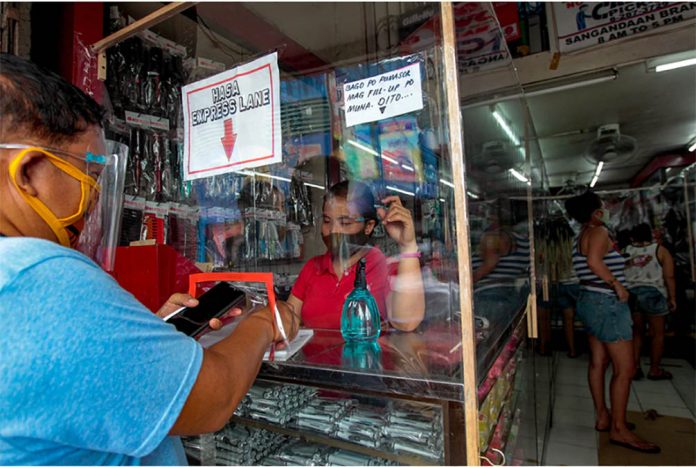 firms Customers provide contact details for contact tracing before being entertained at a shop selling beauty products in Caloocan City. JONATHAN CELLONA/ABS-CBN NEWS