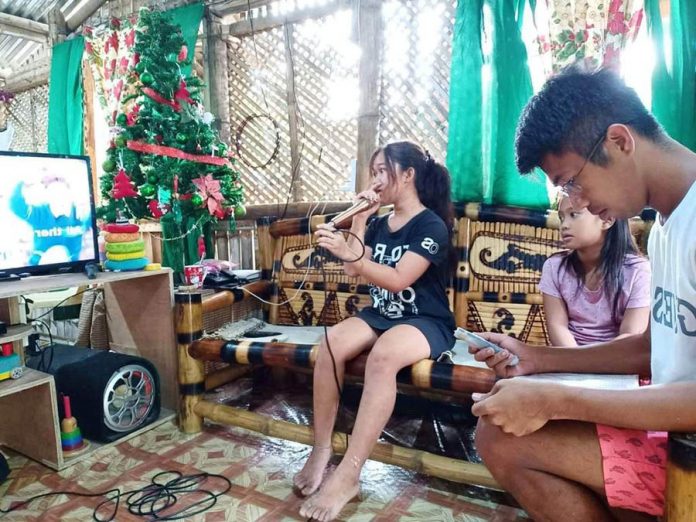 front pic MARK ANTONY MOMBAY Karaoke singing is a favorite pastime of many Ilonggos just like this family. But during this time of pandemic, the city government of Iloilo is banning daytime karaoke sessions and other noisy activities that may distract learners attending classes at home.