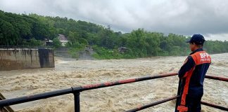 Personnel of the Bureau of Fire Protection monitors the Jalaur Diversion Irrigation Dam in Barangay Moroboro, Dingle, Iloilo on Monday, Oct. 26, 2020. The dam’s water level rose due to rainfall dumped by Typhoon “Quinta". BFP-DINGLE