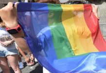 A young participant holds a rainbow flag in front of the parliament building in Budapest during the Pride Parade in the Hungarian capital. AFP