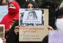 Women hold placards during a protest after the death of a rape victim, on a street in Mumbai, India, Oct. 6, 2020. FRANCIS MASCARENHAS/REUTERS