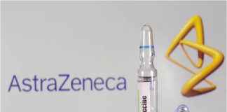 A test tube labeled with the vaccine is seen in front of AstraZeneca logo in this illustration taken on Sept. 9, 2020. DADO RUVIC/REUTERS
