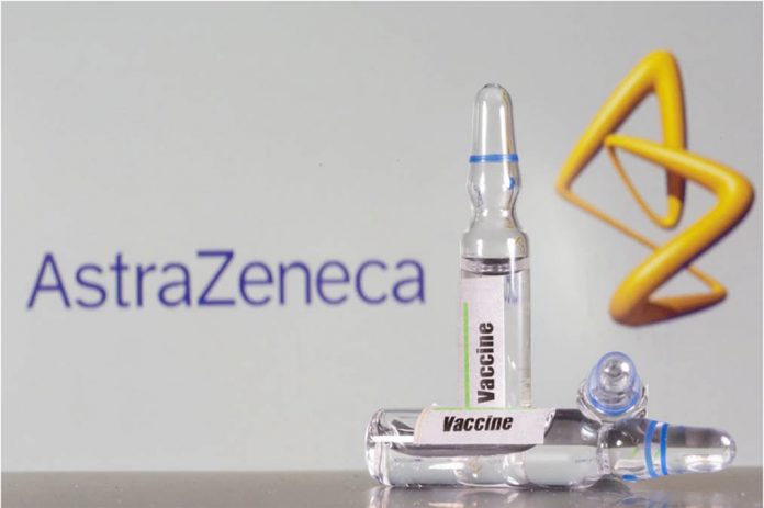 A test tube labeled with the vaccine is seen in front of AstraZeneca logo in this illustration taken on Sept. 9, 2020. DADO RUVIC/REUTERS