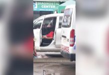 Taxi driver Jovie Lauron lies lifelessinside his parked vehicle Thursday morning in Barangay Divinagracia, Jaro, Iloilo City. REX JALBUENA VIA BOMBO RADYO ILOILO