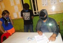 2 Molo locals fall in buy-bust An antidrug operative conducts an inventory of the illegal drugs seized from Sheena Mayuga (first from left) and Rothfield Blanca during an entrapment operation on Ledesma Street, Iloilo City on Oct. 6, 2020. POLICE STATION 1