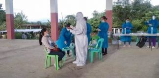 Health personnel collect specimens from an employee of Passi City government during a pooled testing for coronavirus disease 2019. The Passi city hall is closing its doors to the public for three days due to rising of infections. PASSI CITY PIO